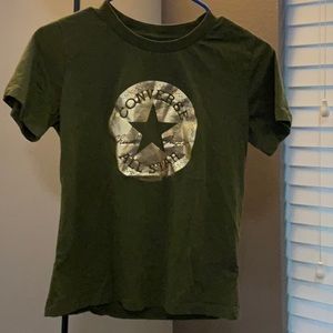 Green Converse shirt.